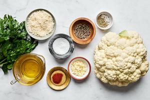 cauliflower, olive oil, garlic, Italian seasoning, salt, paprika, pepper, Parmesan and parsley in prep bowls
