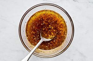 olive oil, garlic, Italian seasoning, salt, paprika and pepper being stirred together in a bowl