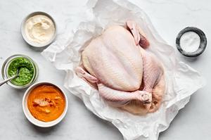 a whole raw chicken, salt, romesco sauce, pesto sauce and garlic aioli for dipping