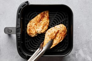 chicken breast well season cooking in an air fryer until juicy and golden