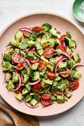 avocado salad made with tomatoes, cucumbers, serrano pepper, herbs and homemade vinaigrette topped with flaky salt