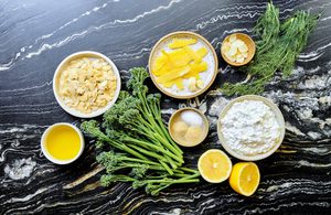 ingredients laid out to make baby broccoli with whipped cottage cheese finished with lemon garlic crisp and fresh dill