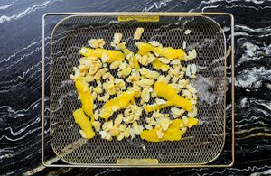 sliced garlic, lemon peel, and almonds tossed with olive oil and ready to be cooked in the air fryer until crispy