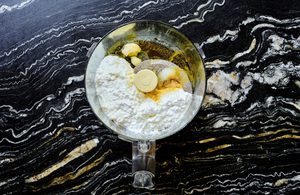 cottage cheese being whipped in a food processor until smooth with garlic, spices, olive oil and lemon juice