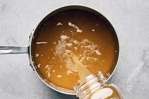 chicken broth being heated in a pot