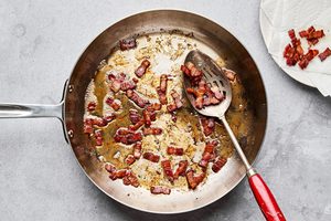 chopped bacon being cooked in a skillet