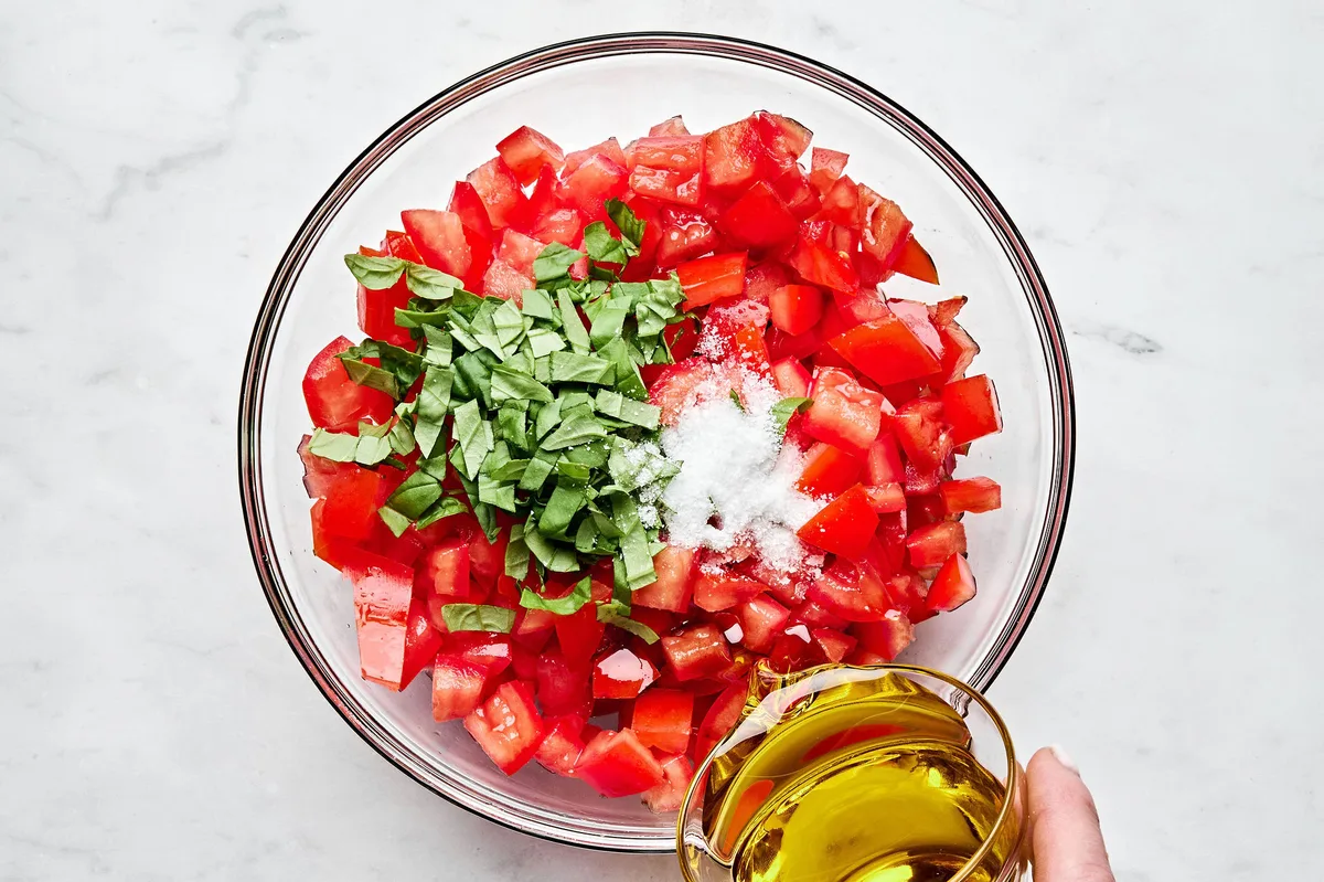 diced fresh tomatoes, salt, fresh basil and olive oil in a bowl to make this easy bruschetta recipe