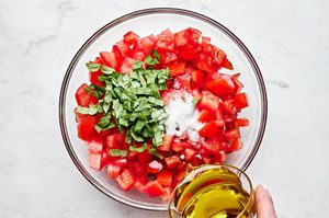 diced fresh tomatoes, salt, fresh basil and olive oil in a bowl to make this easy bruschetta recipe