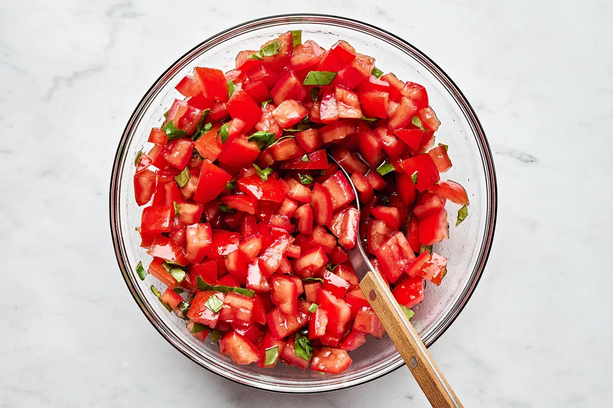 diced fresh tomatoes, salt, fresh basil and olive oil in a bowl to make this easy bruschetta recipe