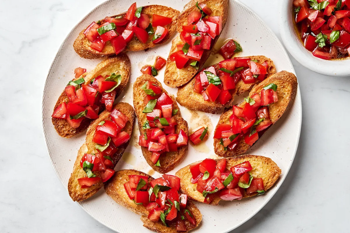 Easy homemade bruschetta recipe with fresh tomato, basil and garlic topping on grilled Italian bread