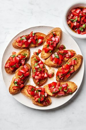 Easy homemade bruschetta recipe with fresh tomato, basil and garlic topping on grilled Italian bread