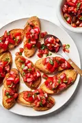 Easy homemade bruschetta recipe with fresh tomato, basil and garlic topping on grilled Italian bread