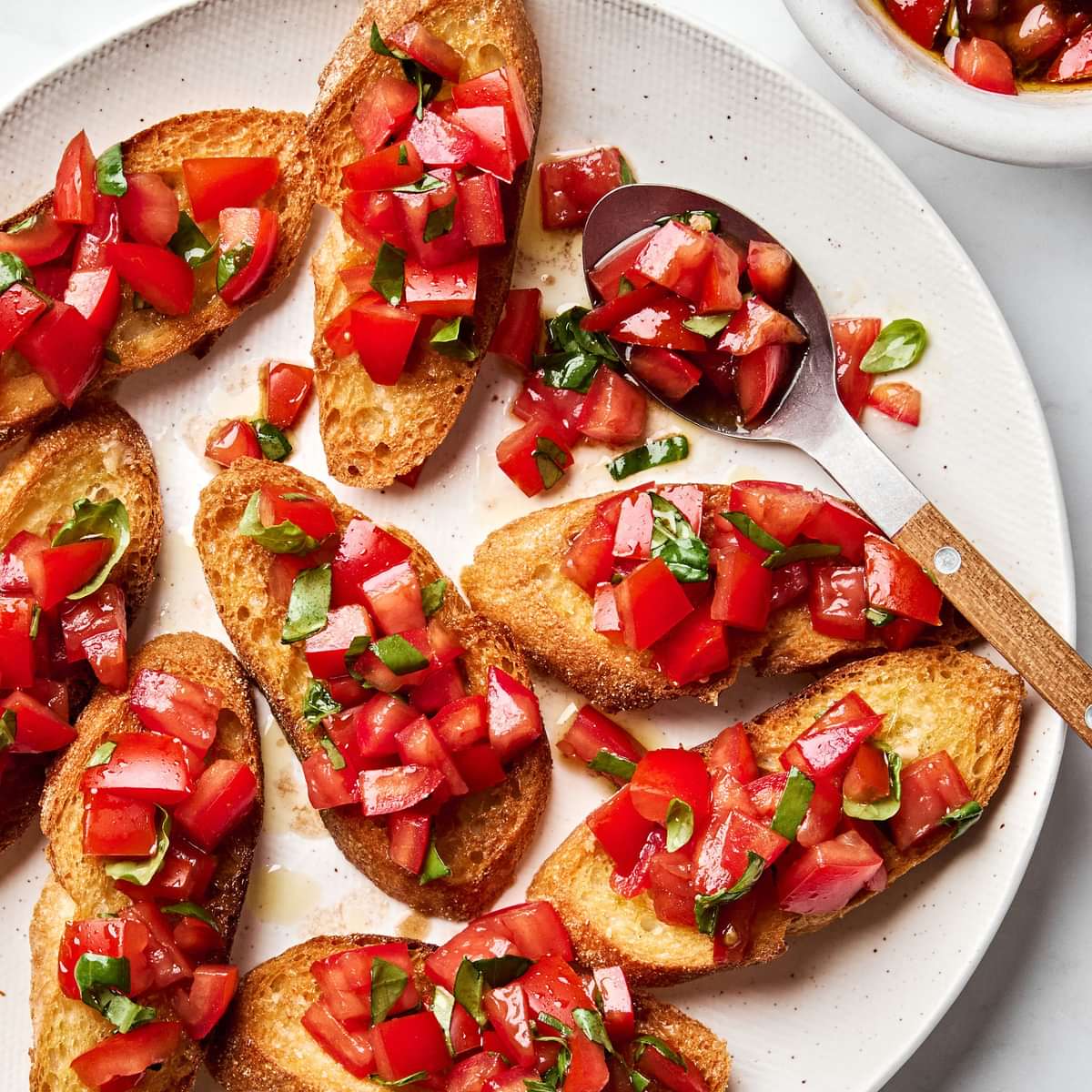 Easy homemade bruschetta recipe with fresh tomato, basil and garlic topping on grilled Italian bread