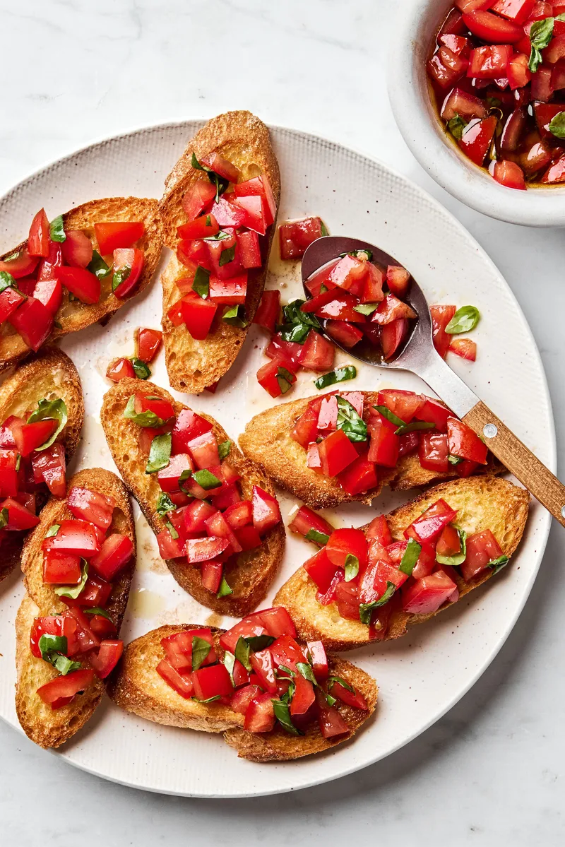 Easy homemade bruschetta recipe with fresh tomato, basil and garlic topping on grilled Italian bread