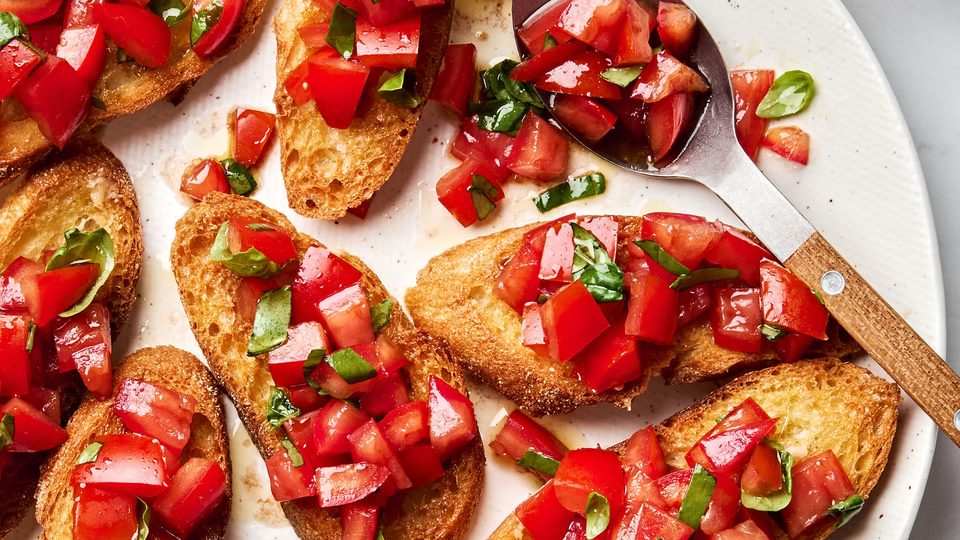 Easy homemade bruschetta recipe with fresh tomato, basil and garlic topping on grilled Italian bread