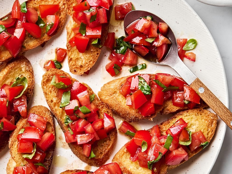 Easy homemade bruschetta recipe with fresh tomato, basil and garlic topping on grilled Italian bread