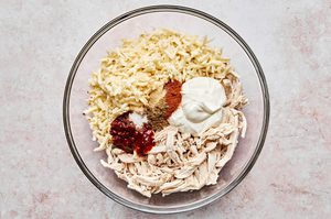 Shredded chicken mixed with spices, sour cream, and cheese to create creamy, flavorful filling for homemade chicken flautas