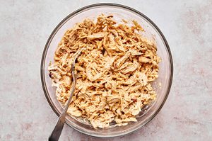 Shredded chicken mixed with spices, sour cream, and cheese to create creamy, flavorful filling for homemade chicken flautas