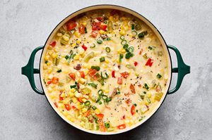a pot of creamy homemade corn chowder with potatoes, bell pepper and crispy chopped bacon