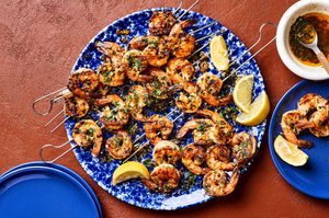 Garlic butter grilled shrimp sprinkled with fresh parsley served on a plate with lemon wedges, a perfect summer seafood meal