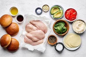 ingredients laid out on a flat surface to make juicy grilled chicken sandwiches with balsamic mayo and marinated tomatoes