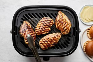 chicken breasts marinated in balsamic mayo being cooked on a grill