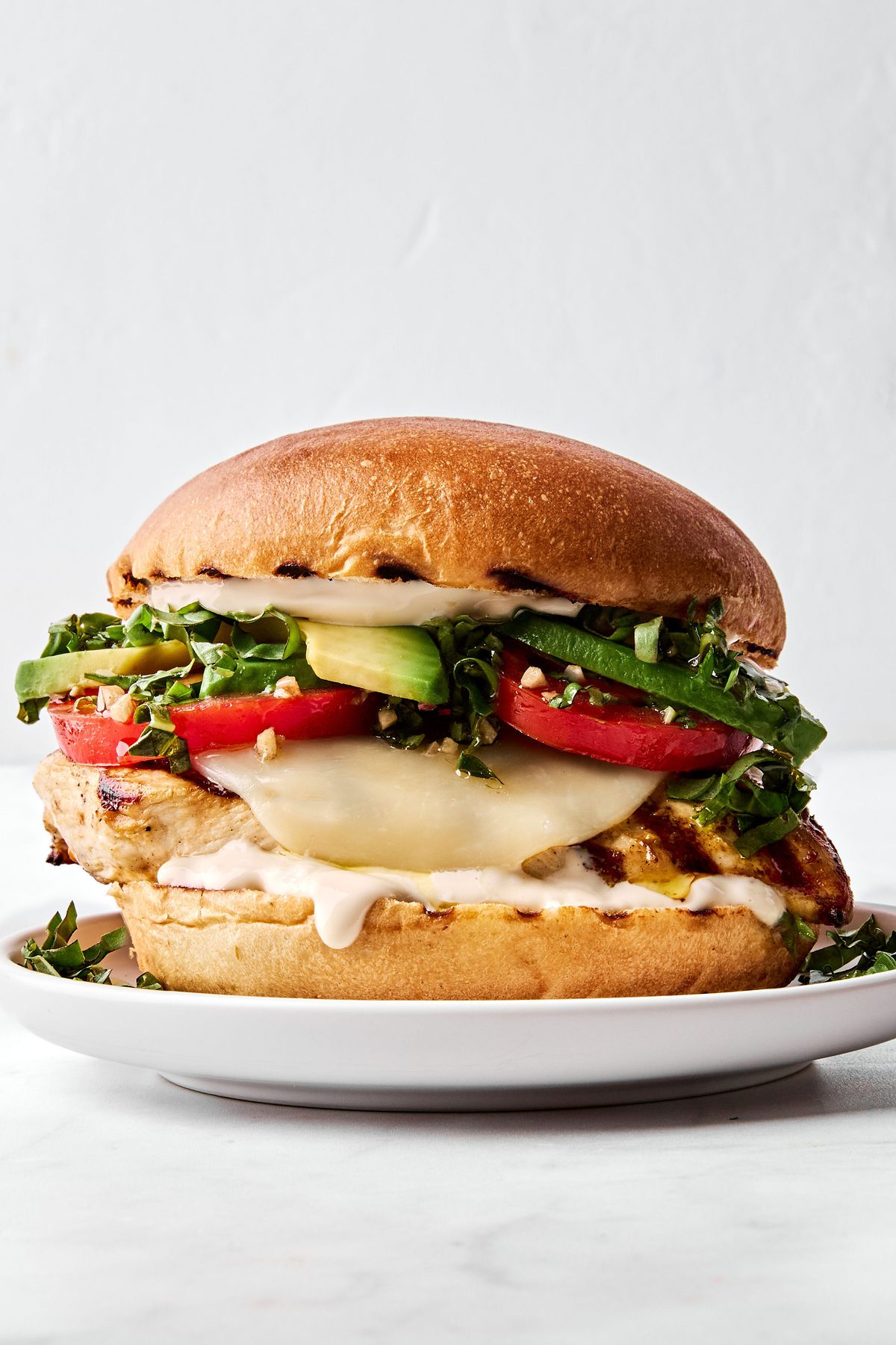 a grilled chicken sandwich with provolone, marinated tomatoes, balsamic mayo & avocado, the perfect summer sandwich