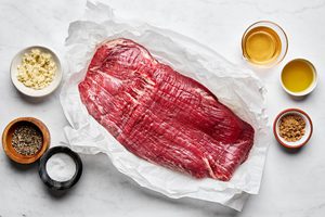 ingredients laid out to make juicy grilled flank steak marinated in apple cider vinegar, olive oil and spices
