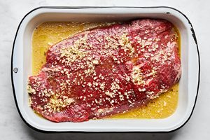 flank steak marinated in a mix of apple cider vinegar, olive oil, garlic, salt, pepper and brown sugar