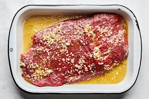 flank steak marinated in a mix of apple cider vinegar, olive oil, garlic, salt, pepper and brown sugar