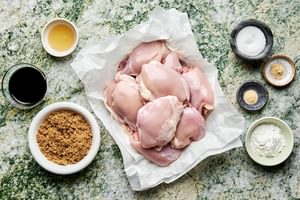 Ingredients for grilled teriyaki chicken laid out, including chicken, soy sauce, ginger, garlic, brown sugar, salt and honey