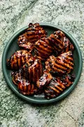 a plate of homemade grilled teriyaki chicken with char marks and sticky, caramelized teriyaki sauce