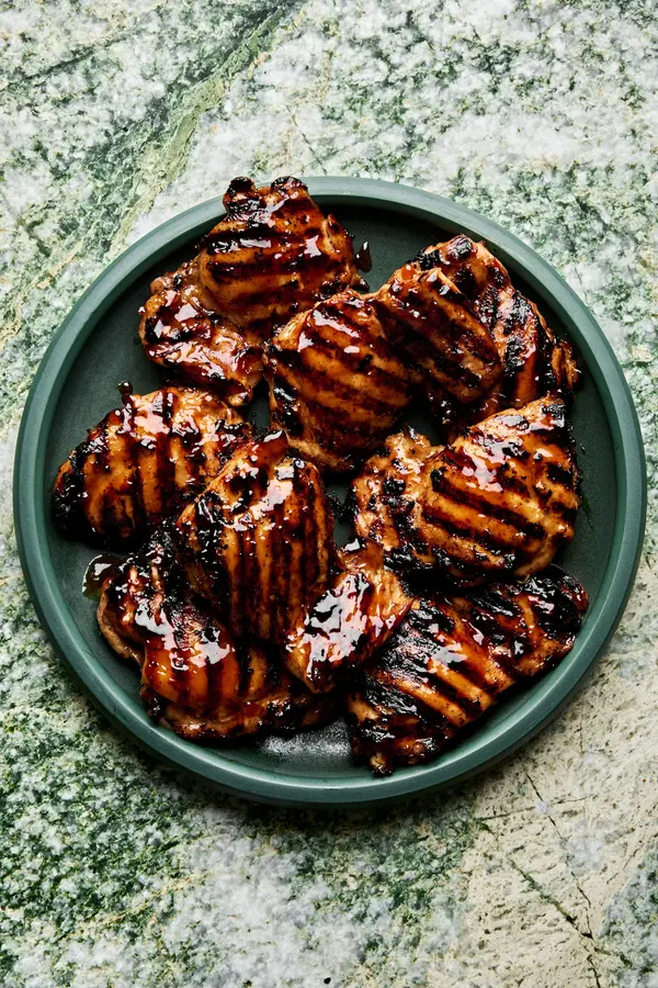 a plate of homemade grilled teriyaki chicken with char marks and sticky, caramelized teriyaki sauce