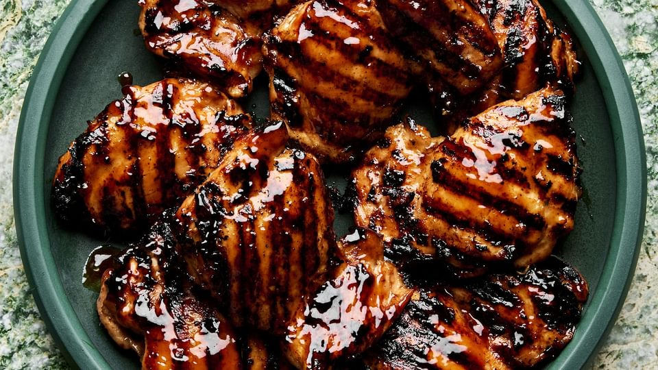 a plate of homemade grilled teriyaki chicken with char marks and sticky, caramelized teriyaki sauce