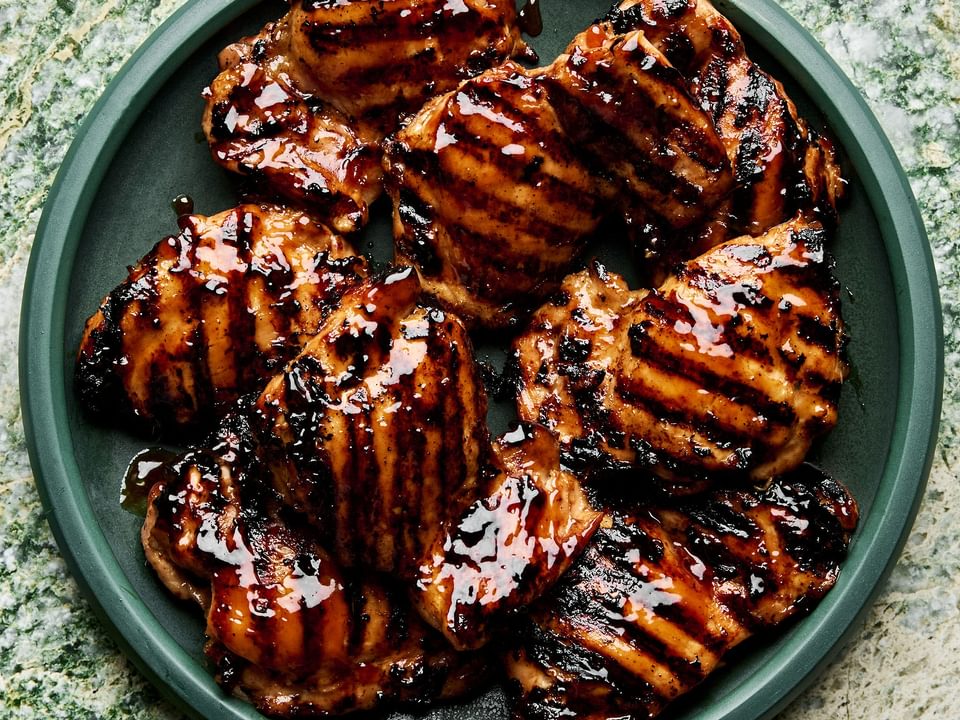 a plate of homemade grilled teriyaki chicken with char marks and sticky, caramelized teriyaki sauce