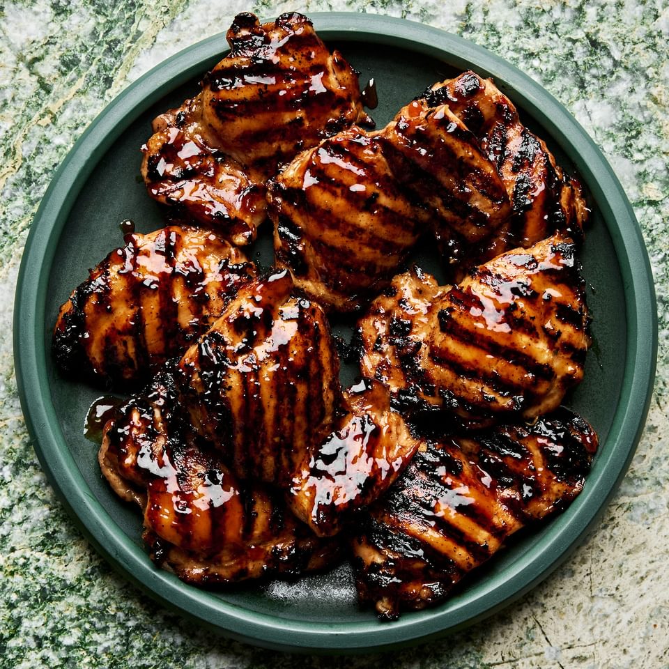 a plate of homemade grilled teriyaki chicken with char marks and sticky, caramelized teriyaki sauce