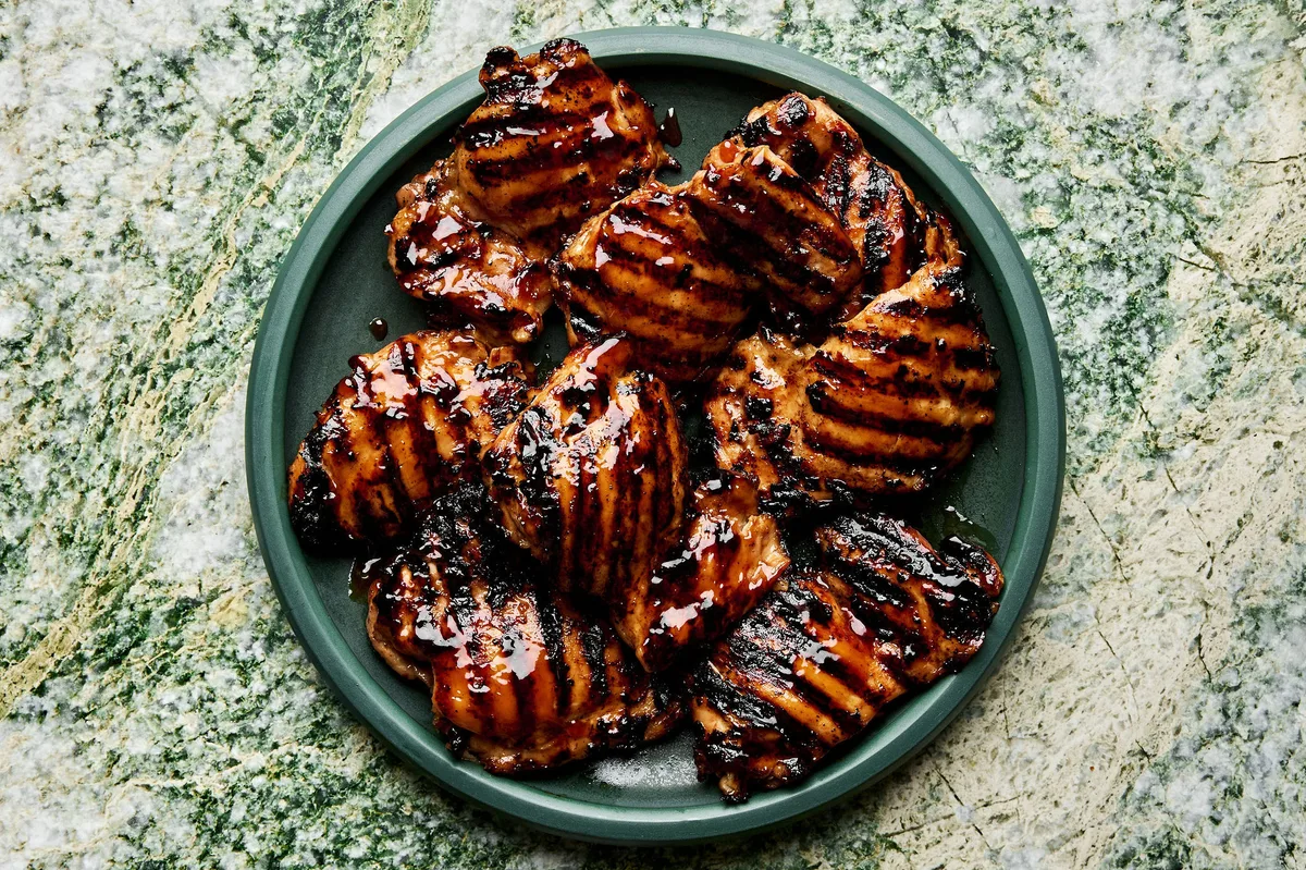 a plate of homemade grilled teriyaki chicken with char marks and sticky, caramelized teriyaki sauce