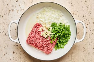 ground beef, bell pepper and onions cooking in a skillet to make a heart ground beef and potato dinner