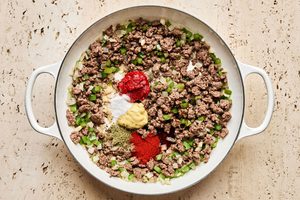 ground beef and spices being cooked in a skillet to make a hearty one pot dinner