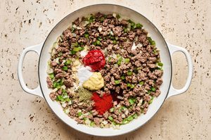 ground beef and spices being cooked in a skillet to make a hearty one pot dinner