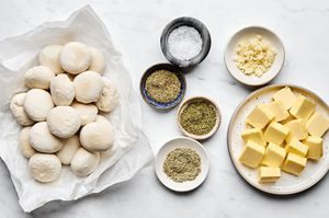 ingredients laid out to dress up rhodes rolls with garlic and herb butter