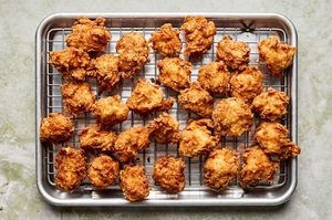 crispy hot honey chicken nuggets cooling on a cooling rack