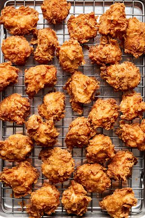crispy hot honey chicken nuggets cooling on a cooling rack