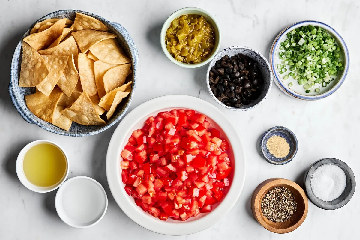 diced tomatoes, chiles, black olives, green onions, avocado oil, and spices in prep bowl to make tomato and olive salsa