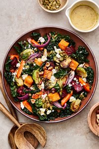 roasted vegetable salad with roasted vegetables& kale with goat cheese, pumpkin seeds, hazelnuts & creamy maple dressing