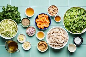 ingredients laid out for a light and healthy sesame chicken salad with miso dressing