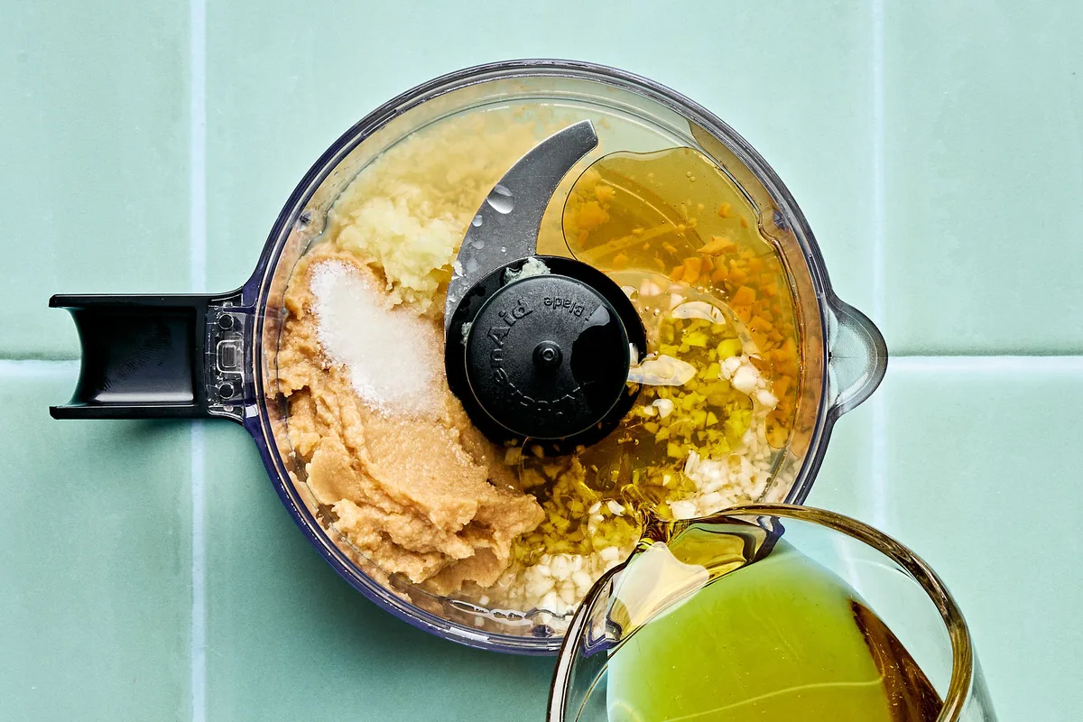 olive oil, miso, vinegar, salt, sesame oil, honey, ginger, garlic, and water in a food processor to make miso dressing