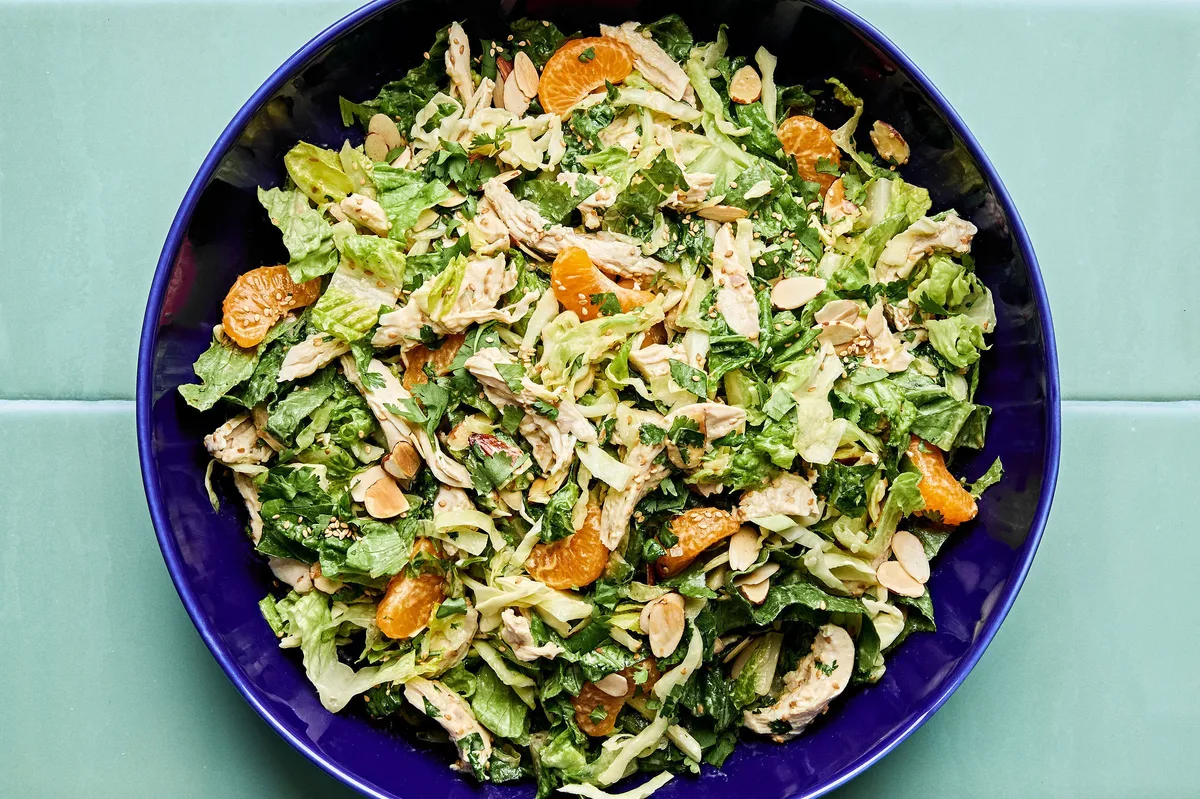 Bright sesame chicken salad with juicy orange slices and sliced almonds with a homemade miso dressing