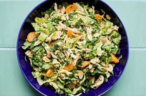 Bright sesame chicken salad with juicy orange slices and sliced almonds with a homemade miso dressing