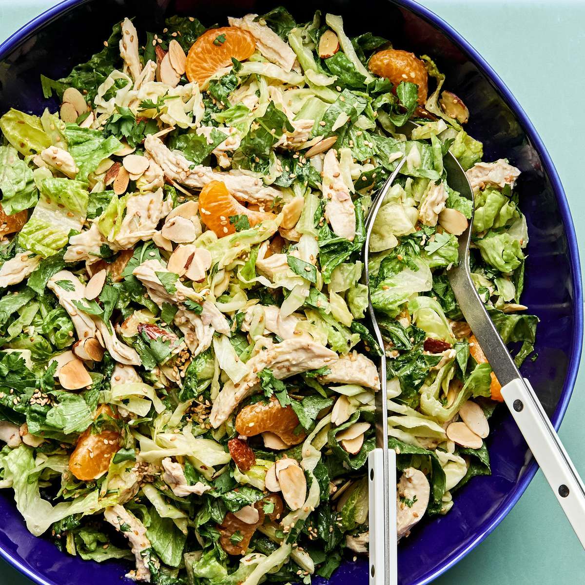 Bright sesame chicken salad with juicy orange slices and sliced almonds with a homemade miso dressing